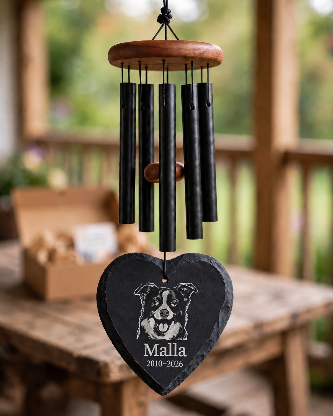 Memorial mockup 2026-10-22 — Malla memorial wind chime with heart slate on a rustic porch