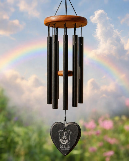 Memorial mockup 2026-10-22 — Malla memorial wind chime in a garden beneath a rainbow